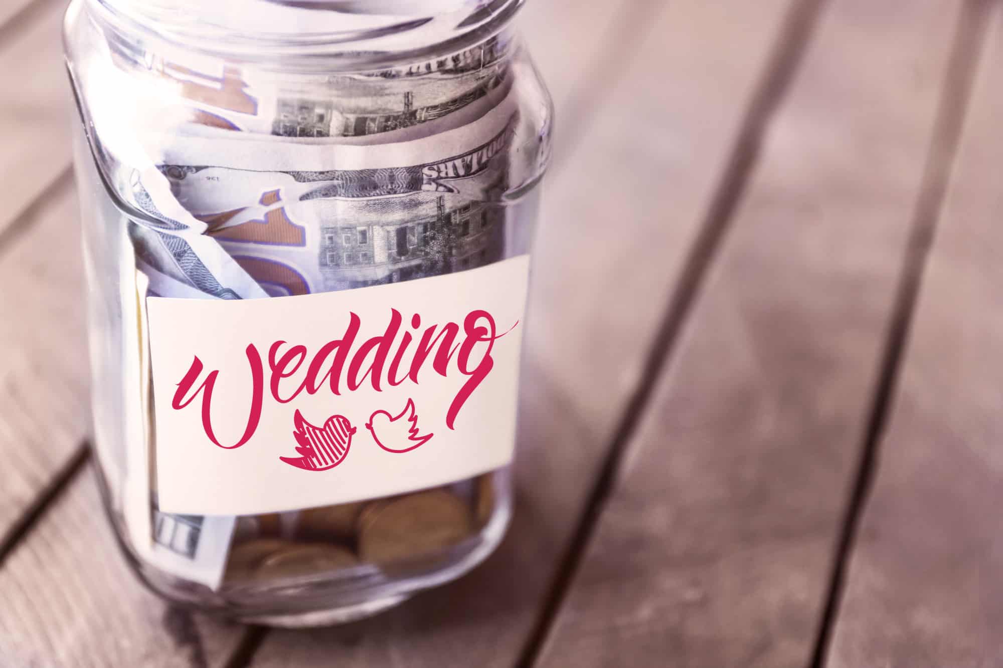 Savings In Glass Bank On Wooden Background